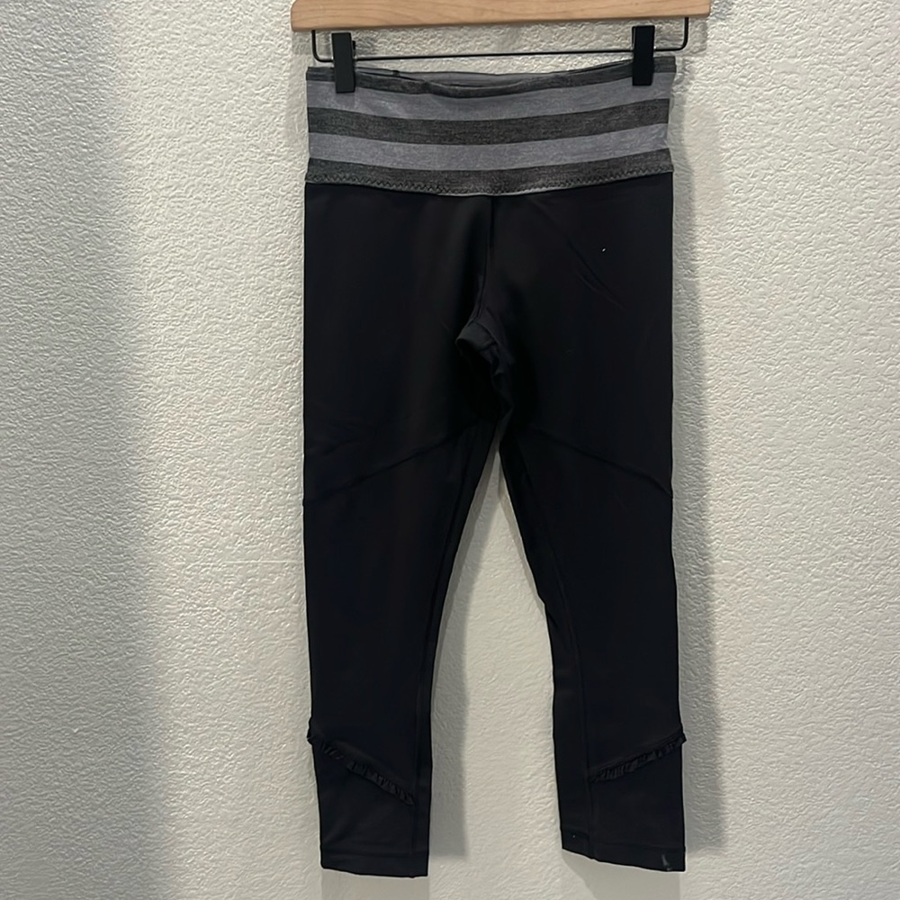 Lululemon black legging with zipper and ruffle at bottom of leg size 4